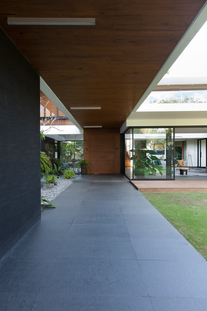 A wooden canopy coaxes visitors to the wide front door
