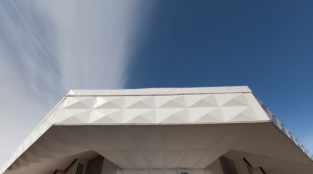 “When I saw that parapet, I really wanted to reuse it,” says Sia. The existing tessellated pattern creeps down toward the corner wall, where the DTI signage is placed.