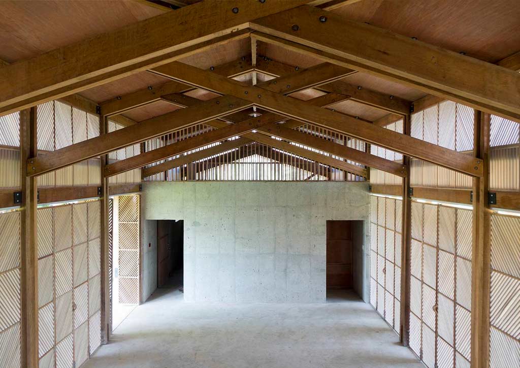 A wide open indoor space with vaulted ceilings flanked by wooden screens.