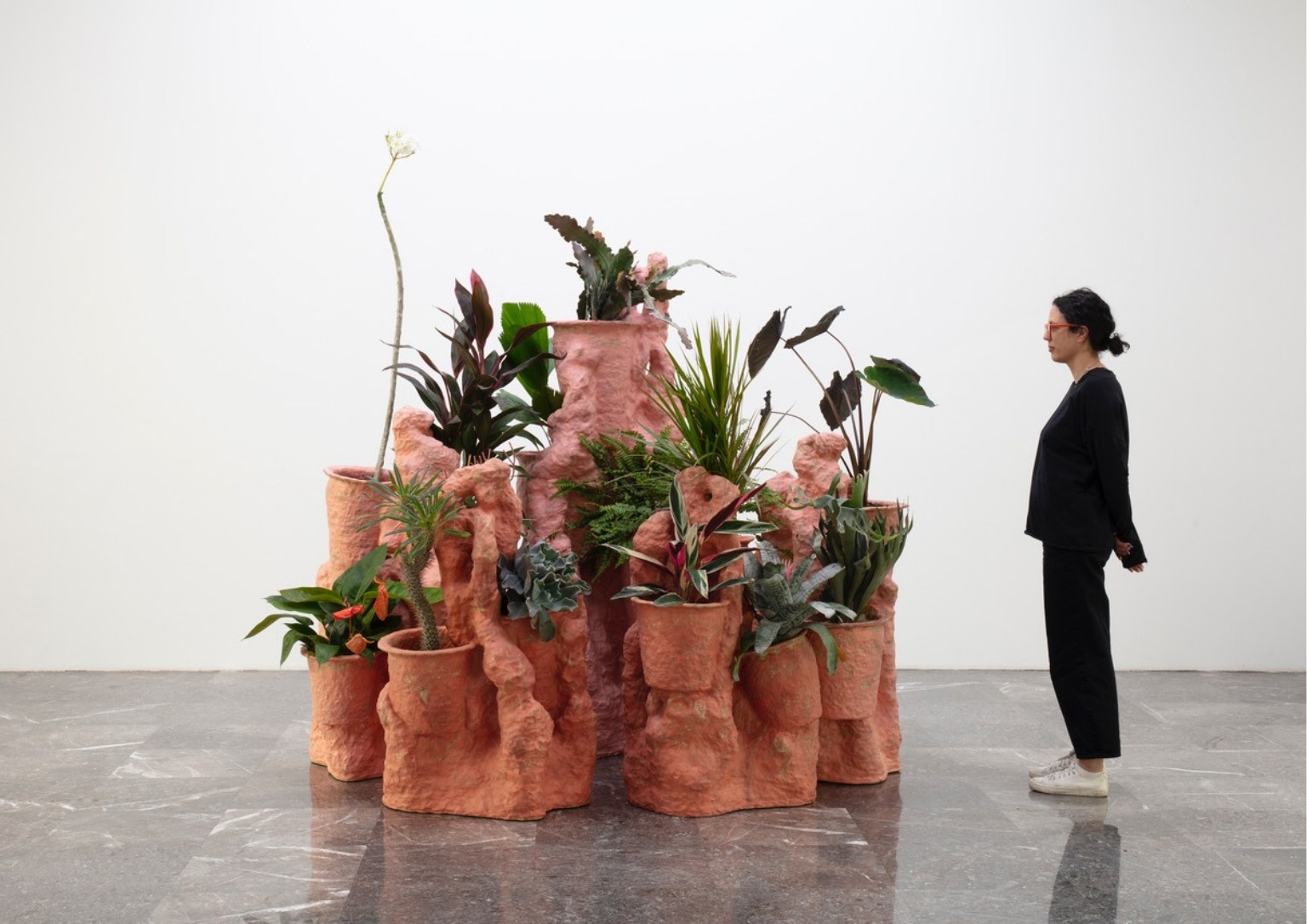 A ceramic sculpture made to hold various plant life