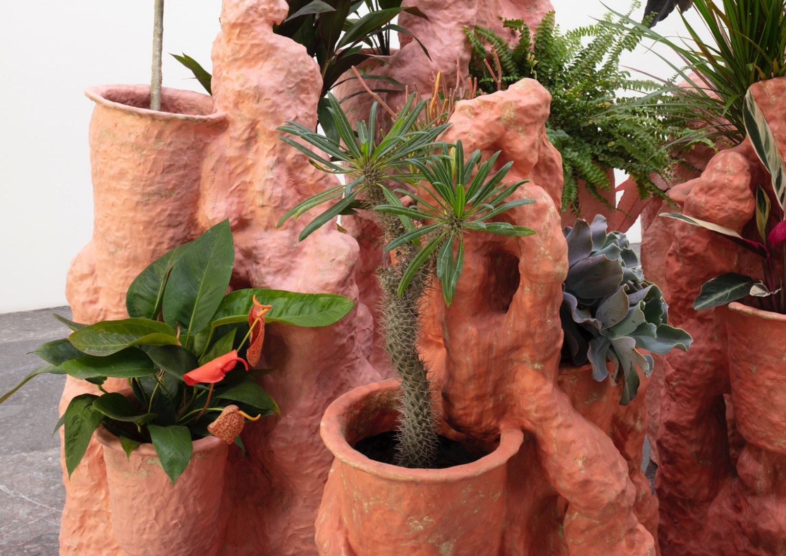 A ceramic sculpture made to hold various plant life