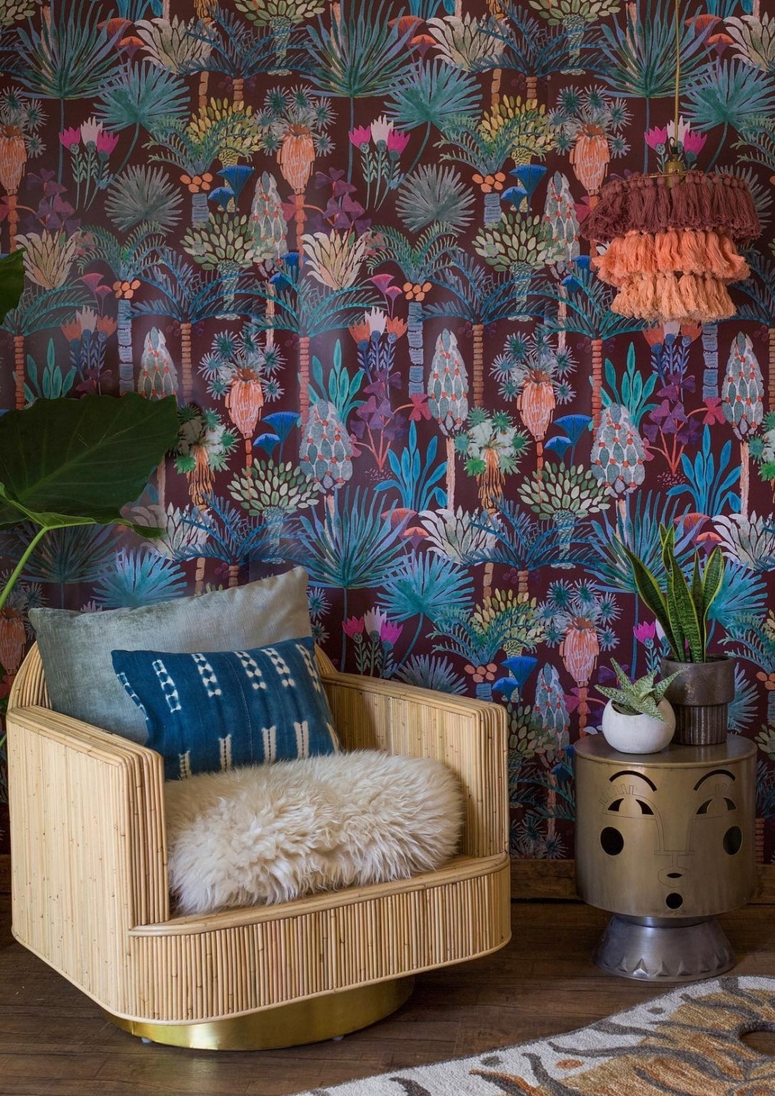 A modern yellow armchair set against colorful biophilic inspired wallpaper