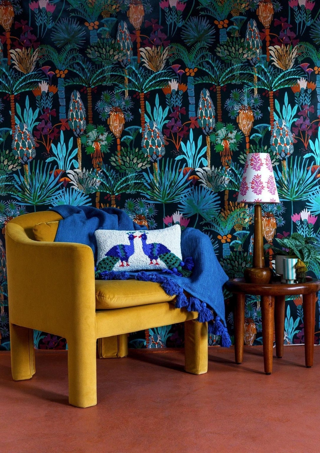 A modern yellow armchair set against colorful biophilic inspired wallpaper