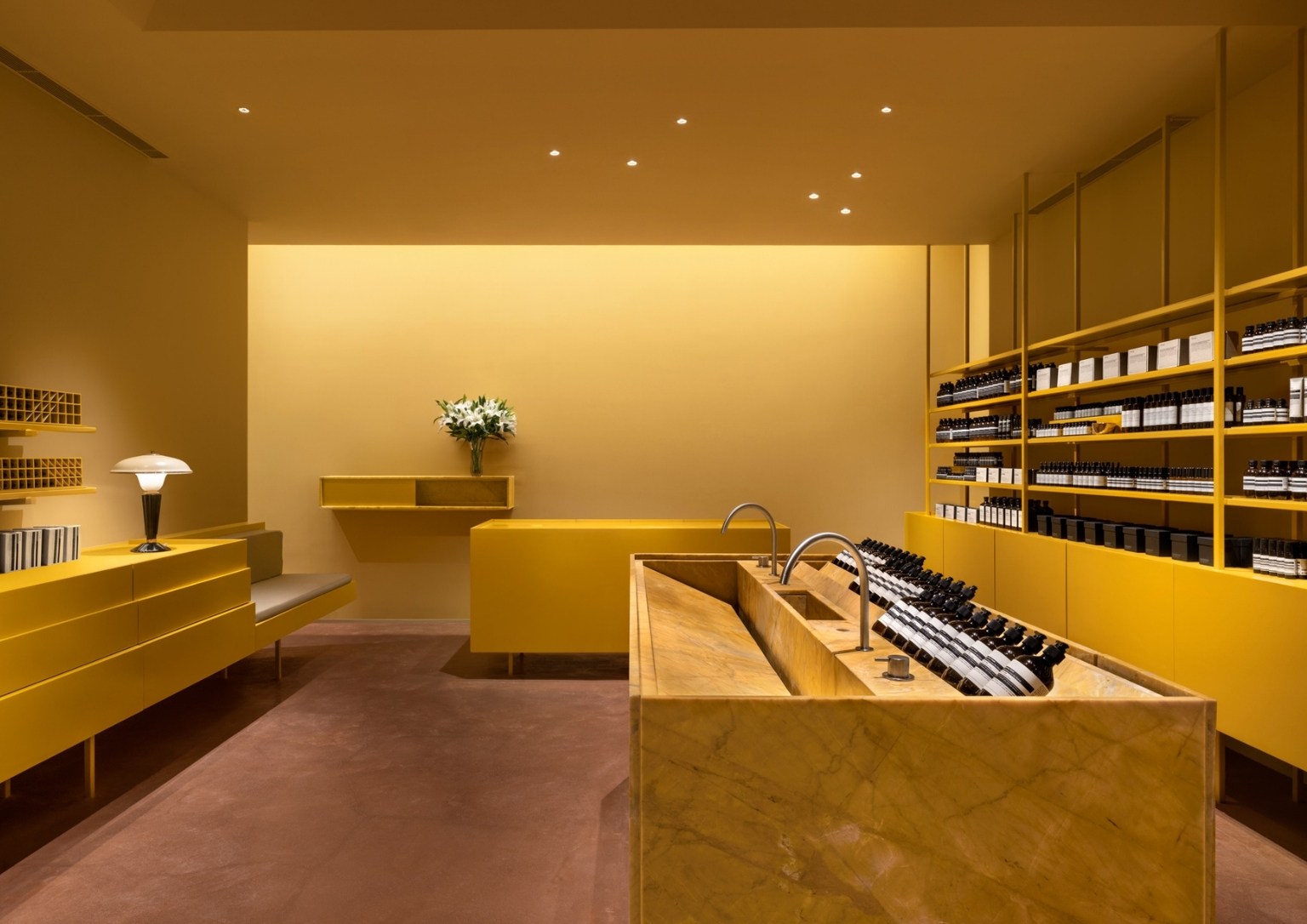 Aesop store's interior showcases their products on minimalist cabinetry.