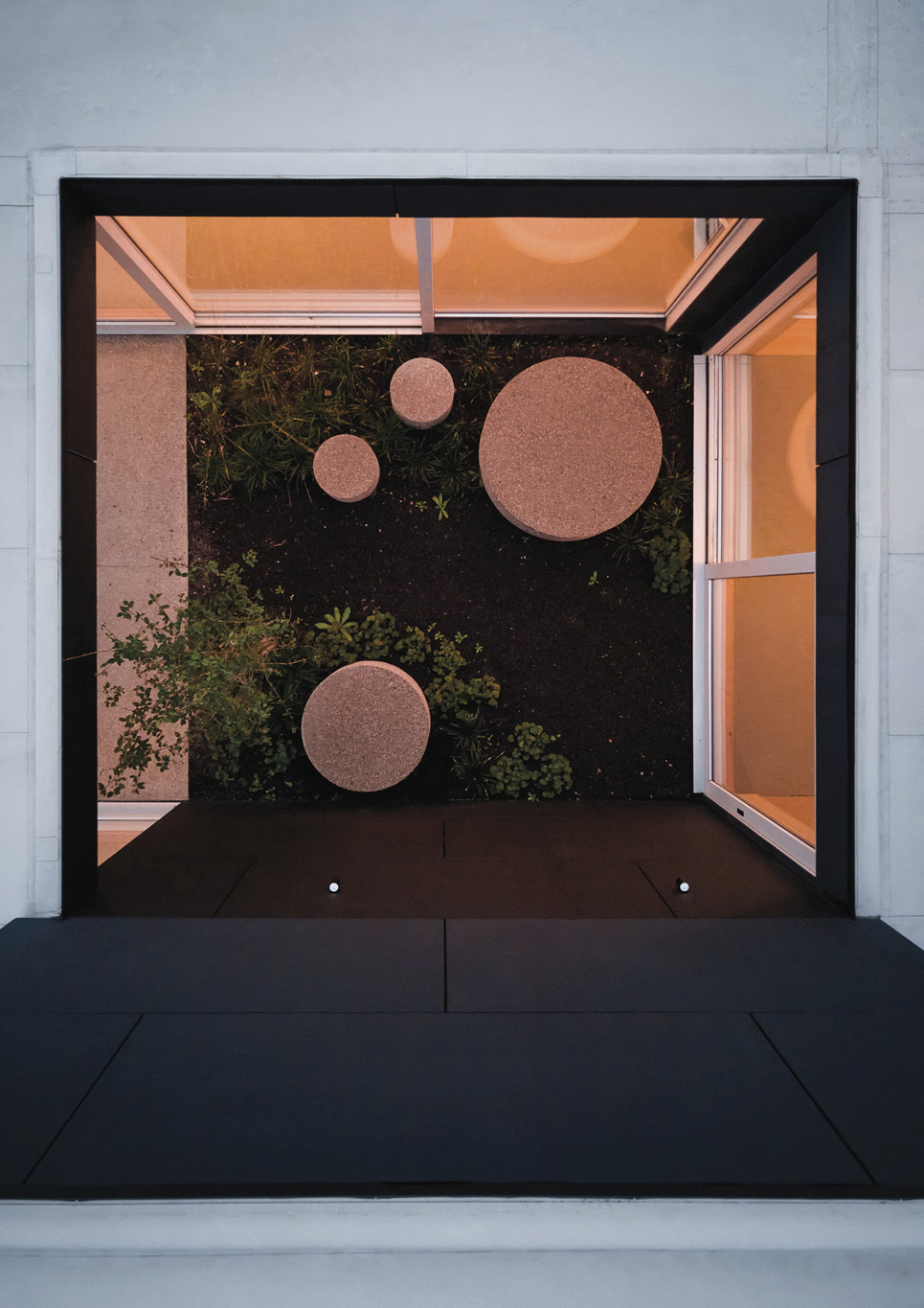 An inner courtyard with pocket garden inside Warm Nest, a Maggie care facility.