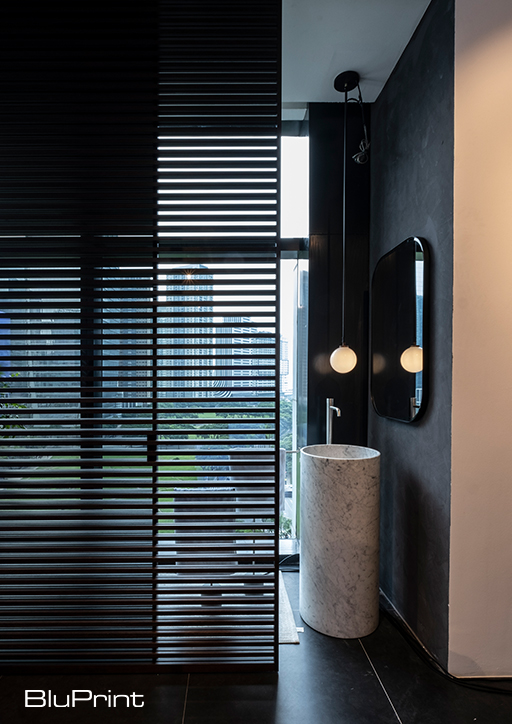 slatted partitions inside a bathroom with pedestal sink