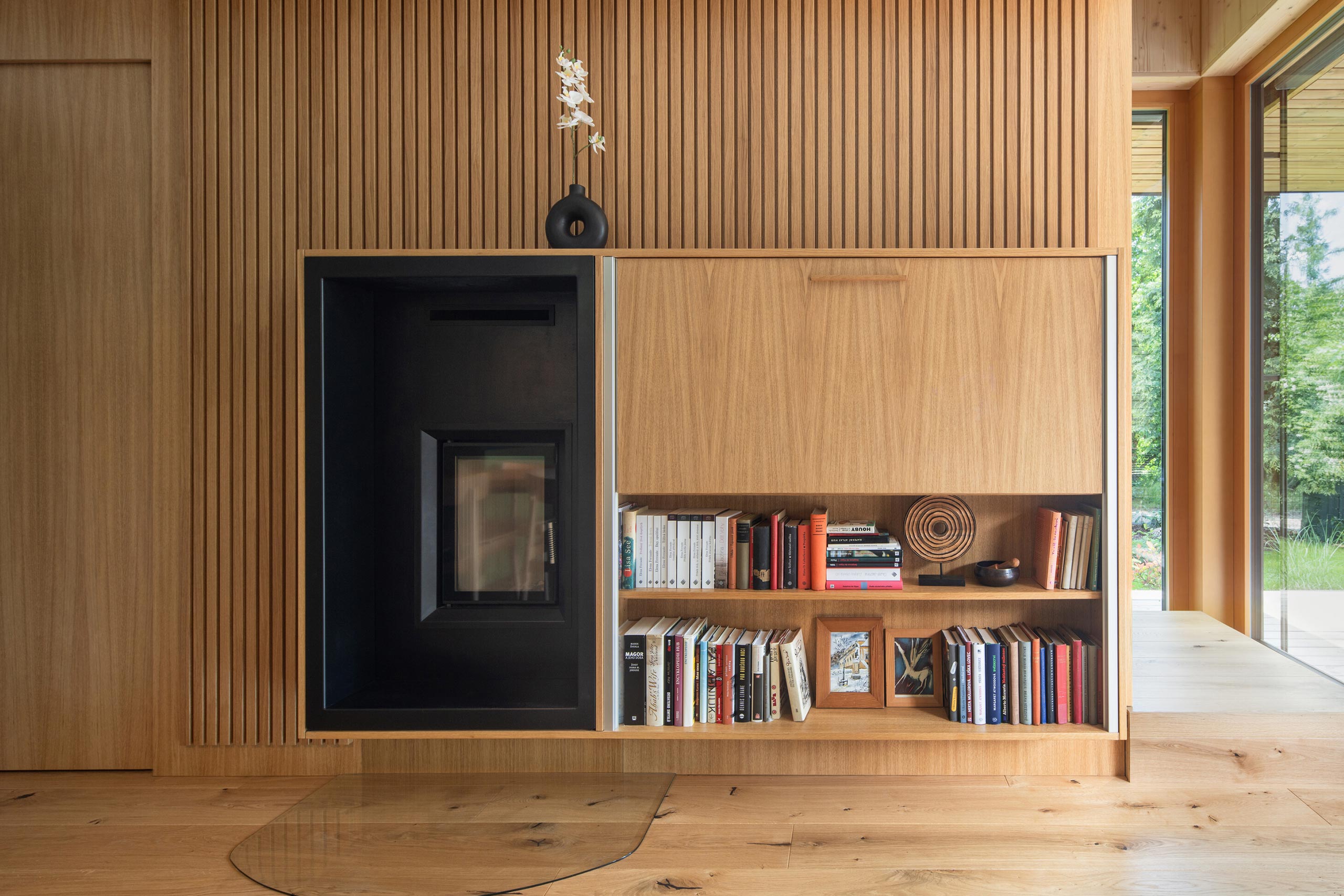 cozy forest cabin interior with wooden walls, cabinetry, and table.