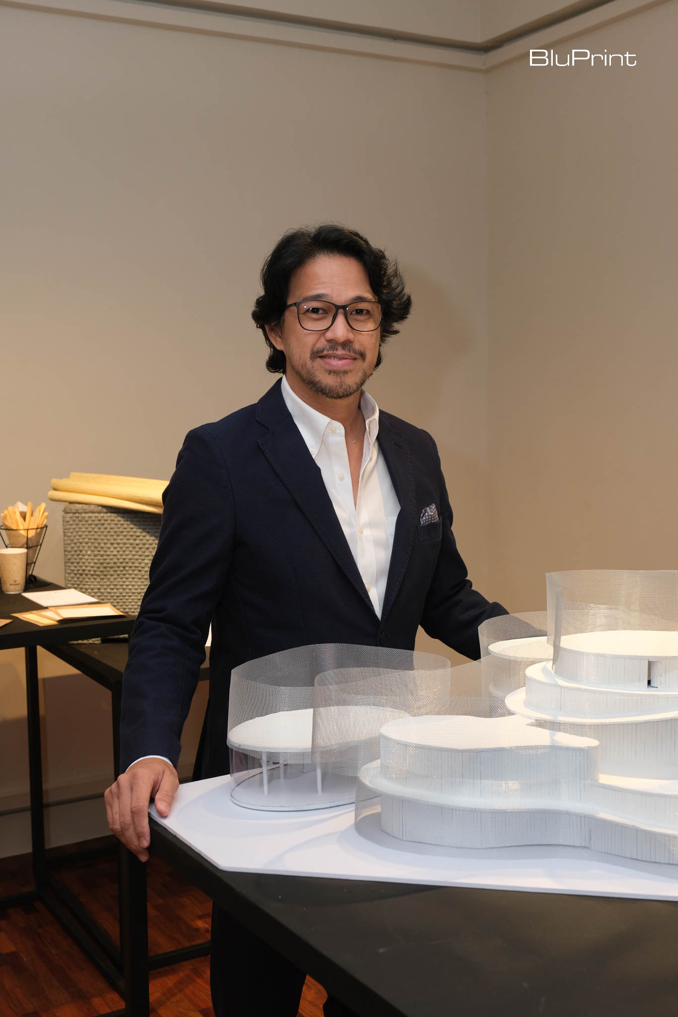 Architect Royal Pineda in front of a scale model of his Dubai Expo Bangkota pavilion. 