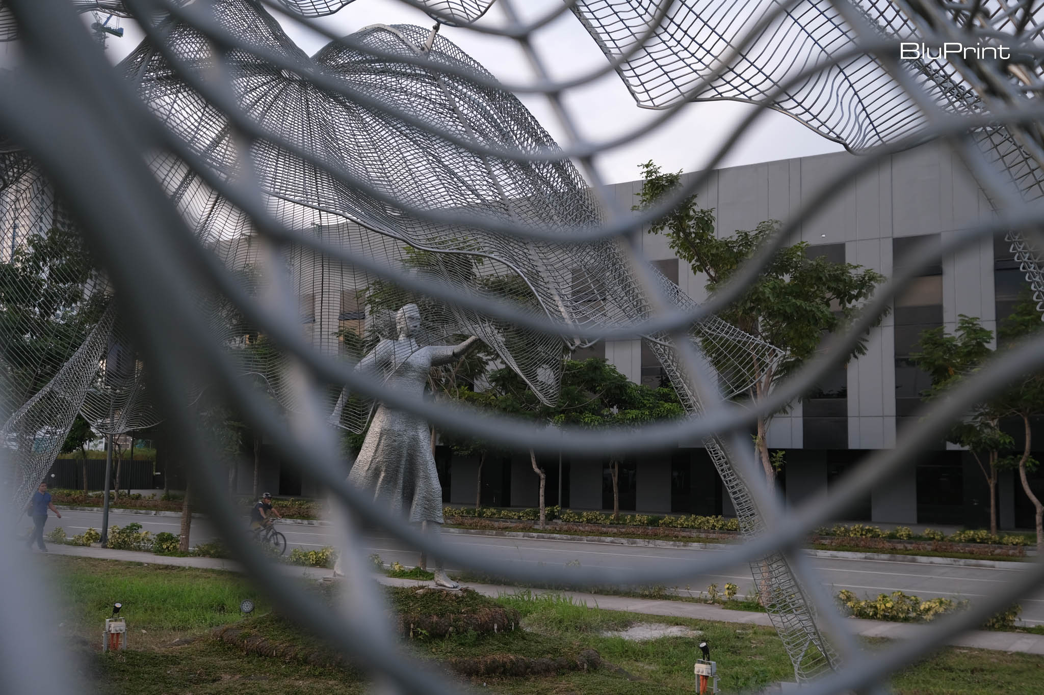 Close up of art installation "Lambat" depicting a woman spreading a fishing net by Jude Tiotuico, Vito Selma, and Miguel Aguas