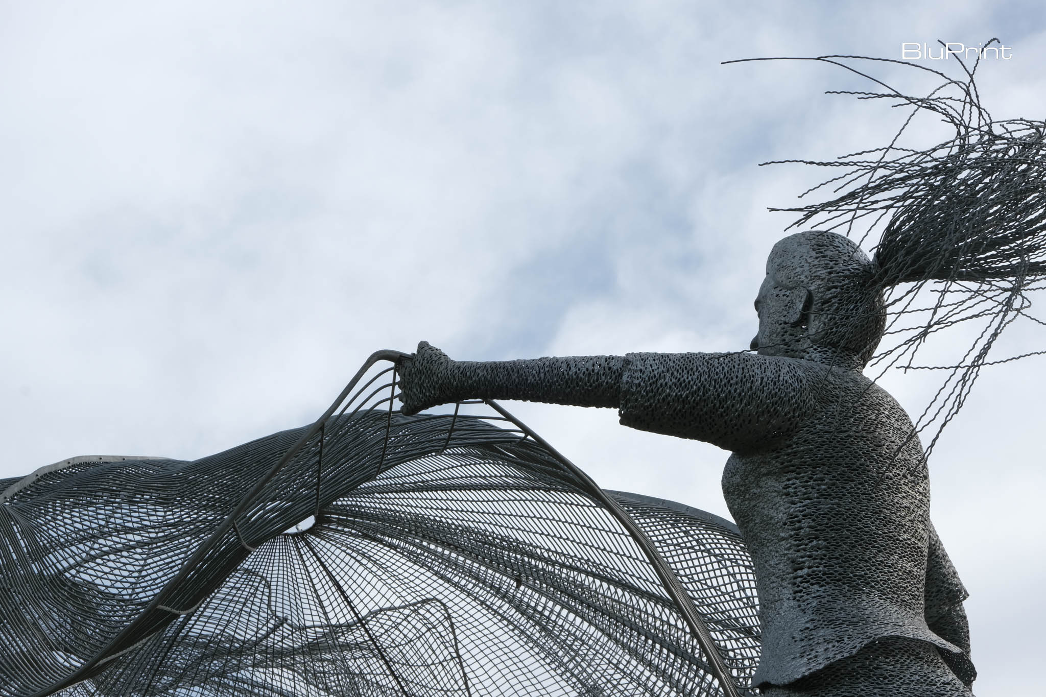 Public art installation Close up of public art "Lambat" depicting a woman spreading a fishing net by Jude Tiotuico, Vito Selma, and Miguel Aguas