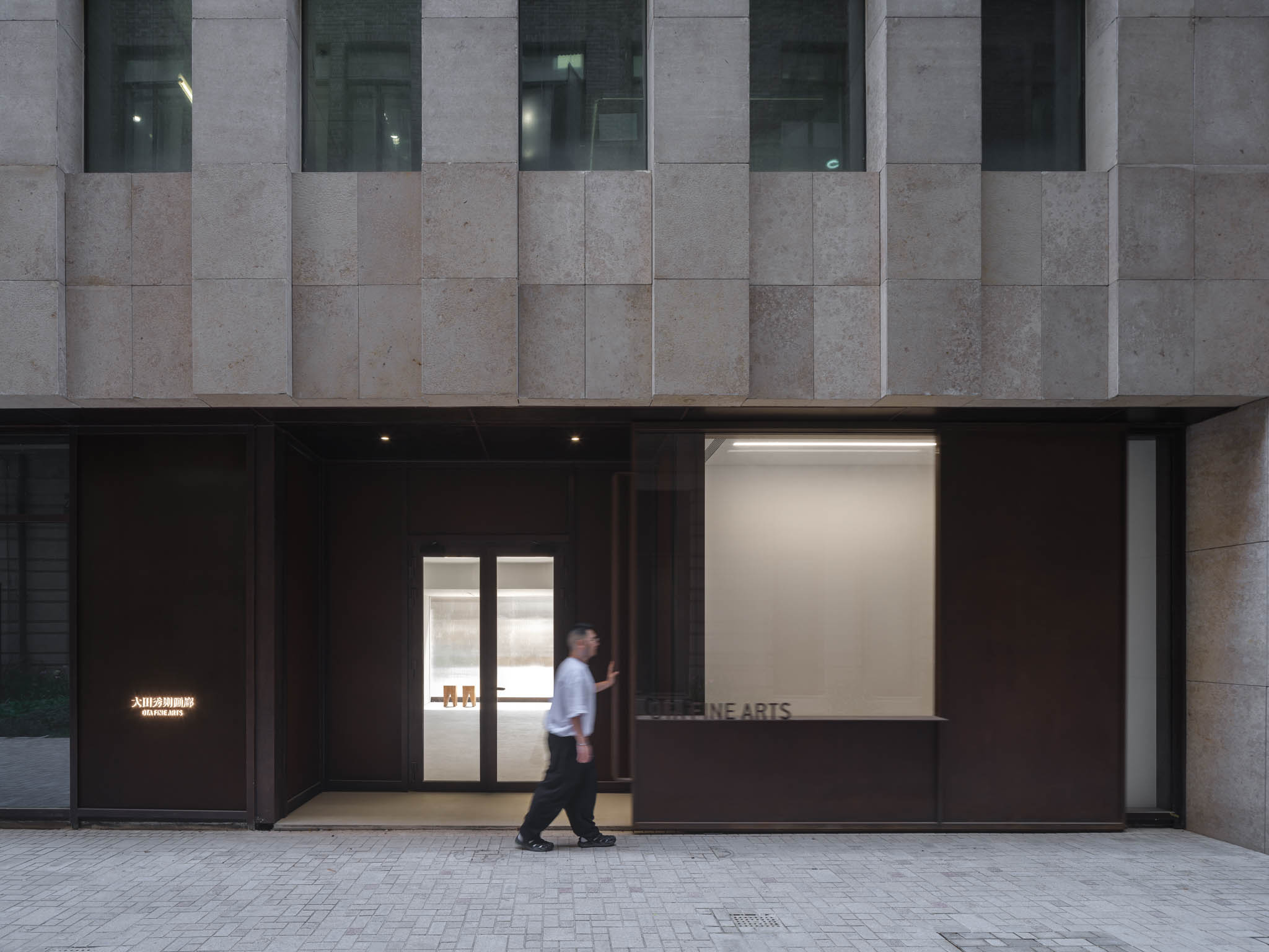 BluPrint-2023-December-IN-ARTICLE-(NERI AND NU)-09 - BluPrint A man opens a large aged-metal sliding door to the gallery's entrance