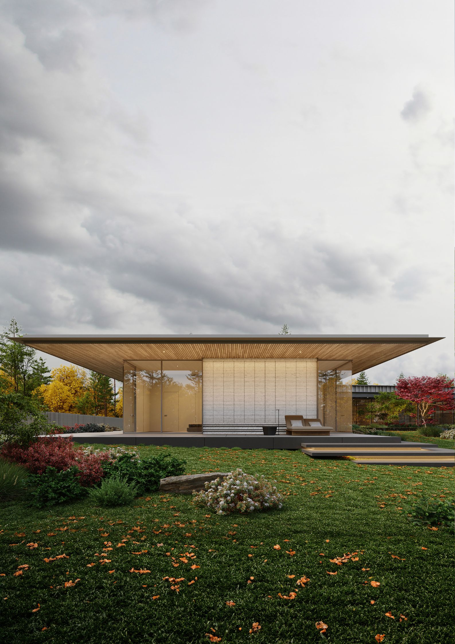A cantilevered roof extends over an outdoor seating area for relaxation and socialization. Natural wood clads the roof’s underside to soften the otherwise contemporary lines. The landscaping further complements the structure. 