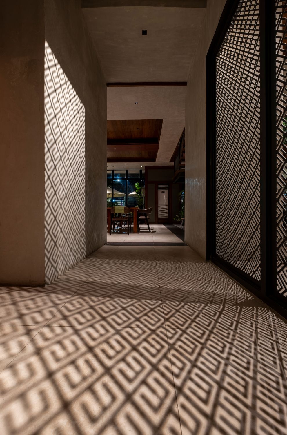 light filters through laser cut panels to create a pattern on the walls and floor at Cafe Bobs.