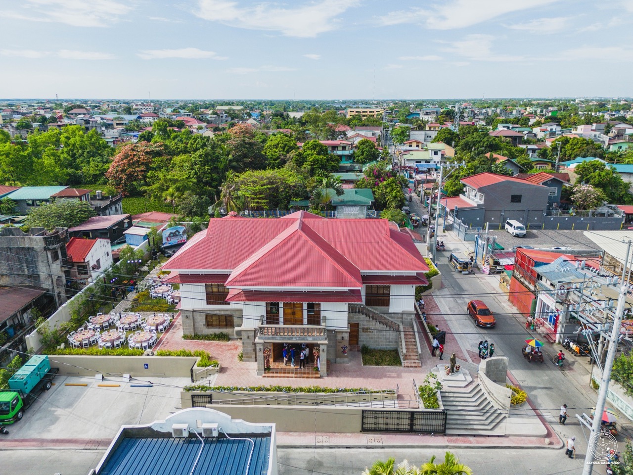 An aerial view of Dr. Pio Valenzuela's bahay na bato, with red pithed roof, stone work on the first level, and white walls on the second floor.