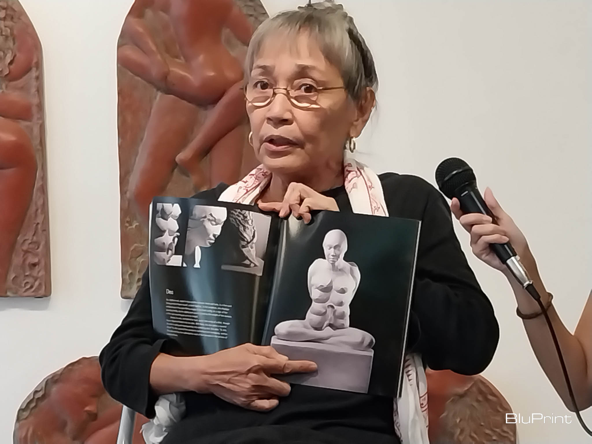 Arellano explaining her past works. Photo by Elle Yap.