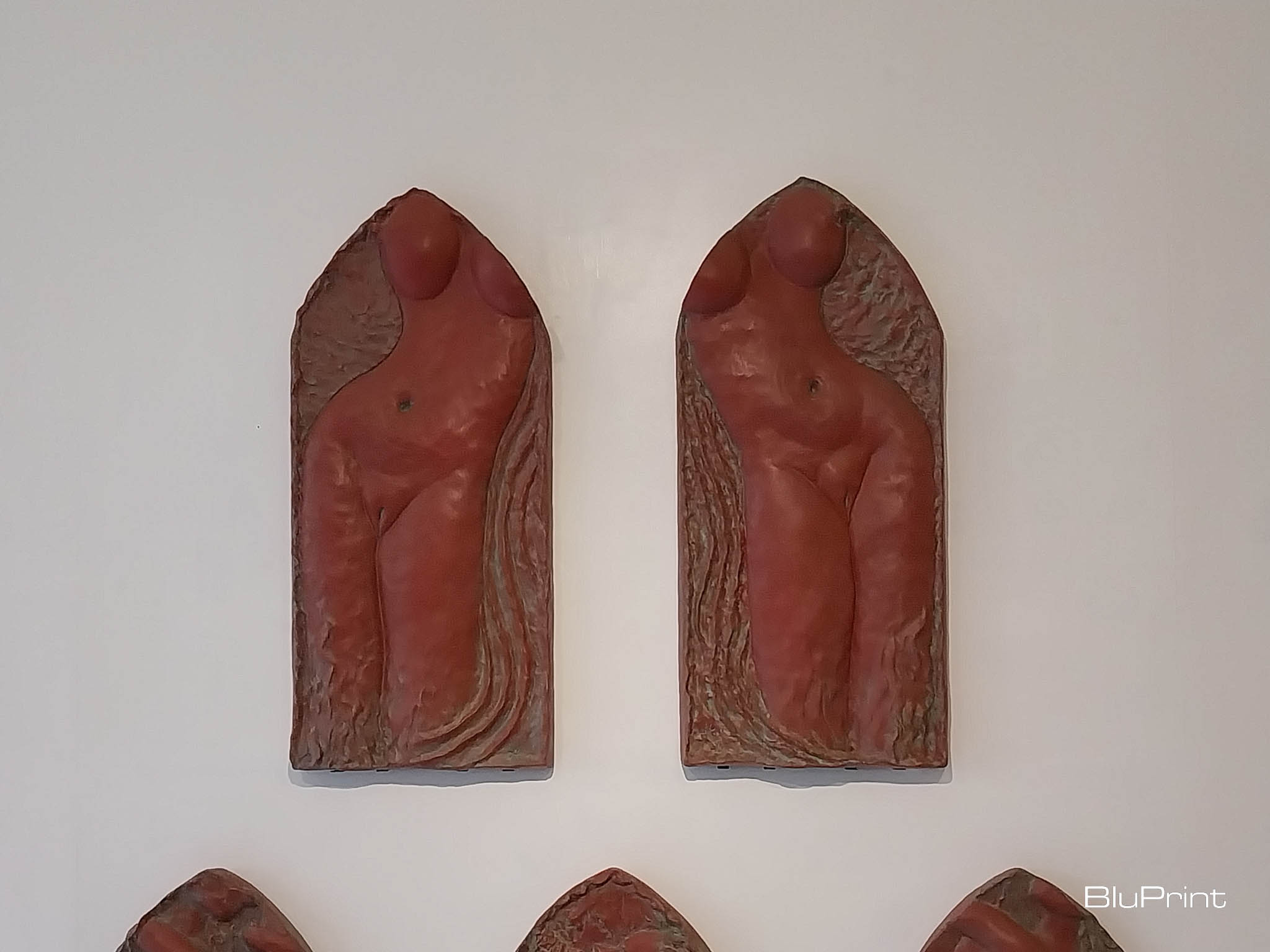 Sculptures hanging on the wall depicting the woman's body. Photo by Elle Yap.