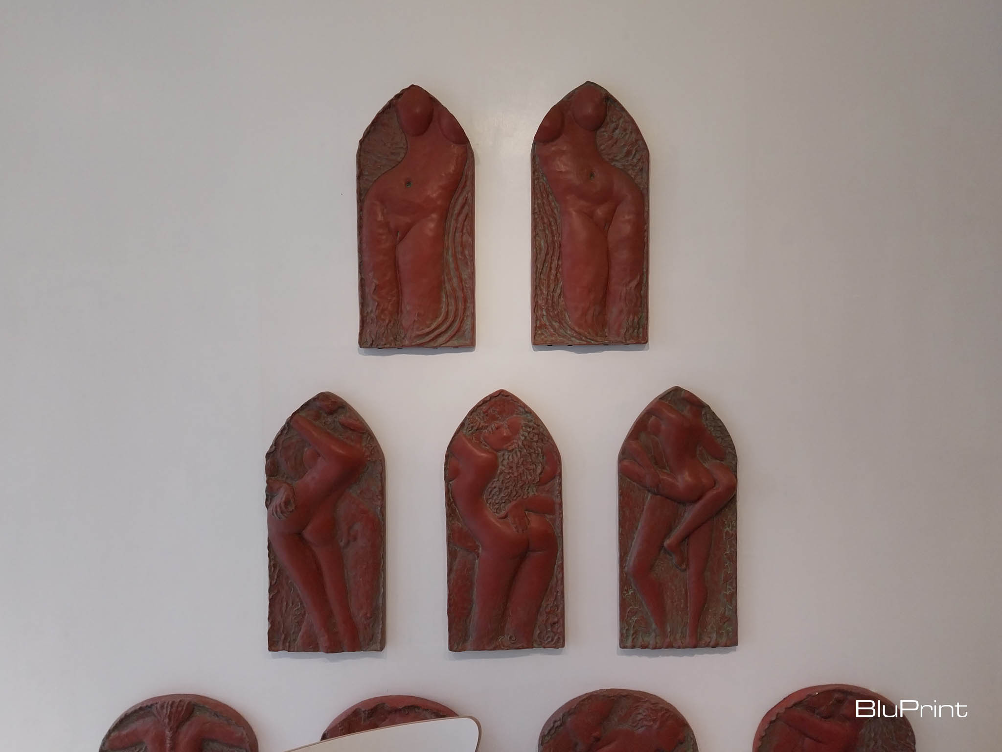 Sculptures hanging on the wall depicting the woman's body. Photo by Elle Yap.