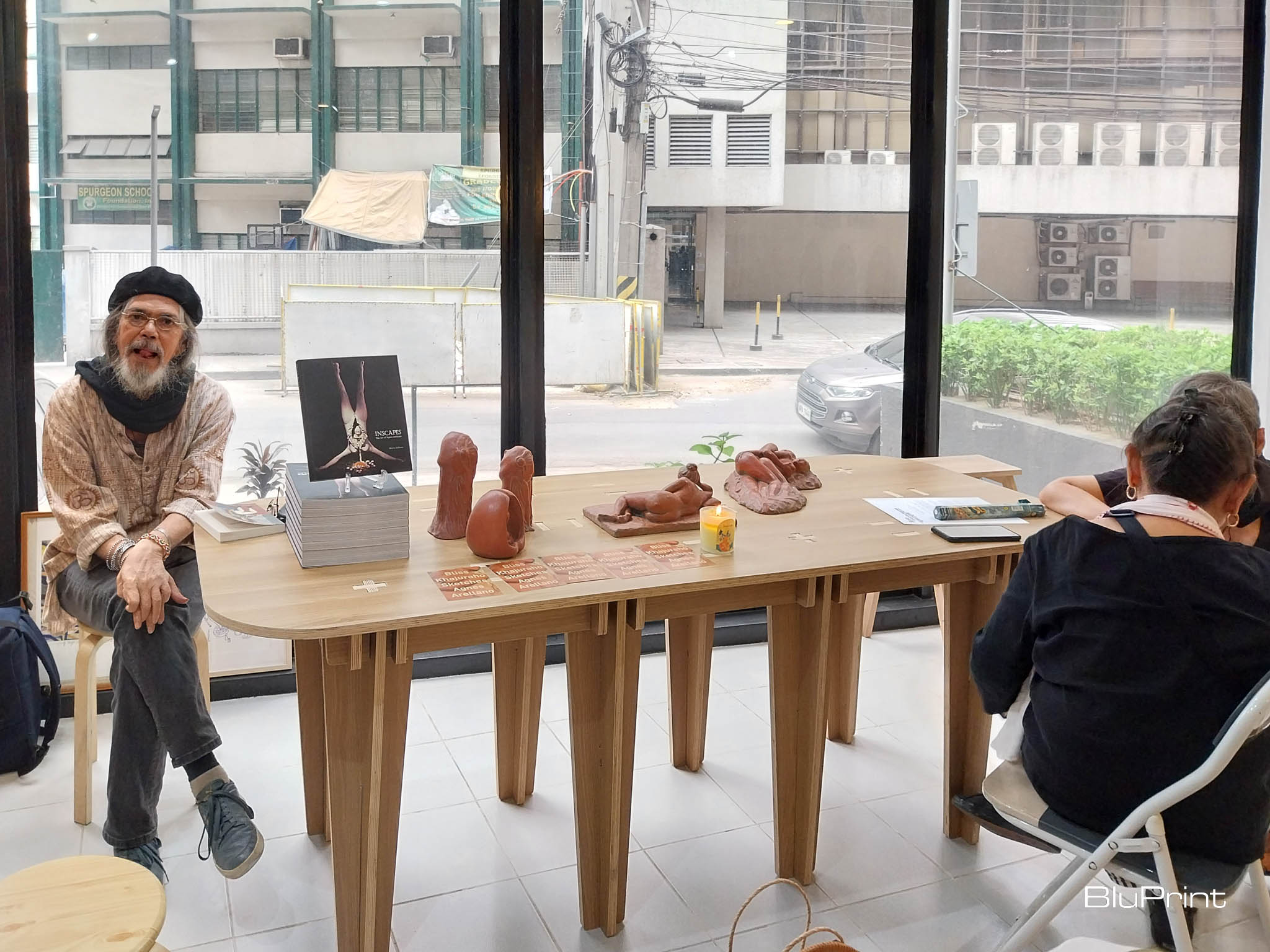 Arellano's partner Billy posting with some of her works. Photo by Elle Yap.