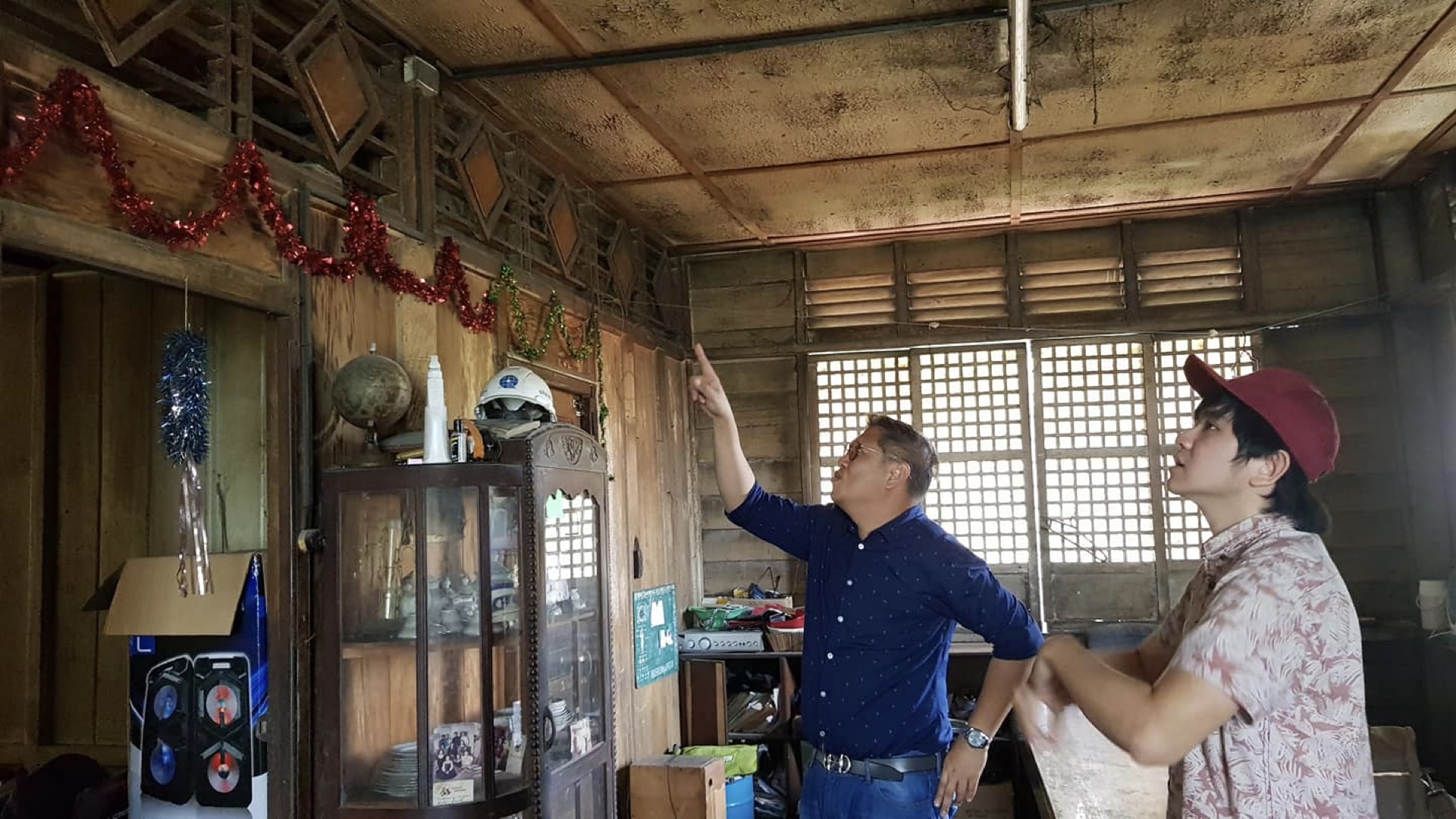 Workers inspect construction of Dr. Pio Valenzuela's bahay na bato, now a museum. walls, and hard wood floors.