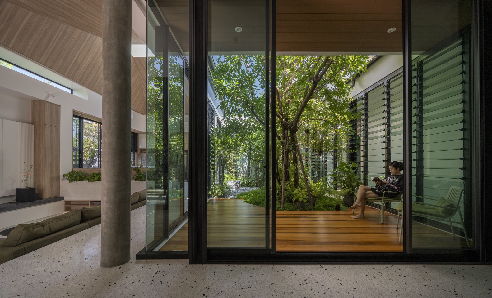 Veranda by an indoor garden.