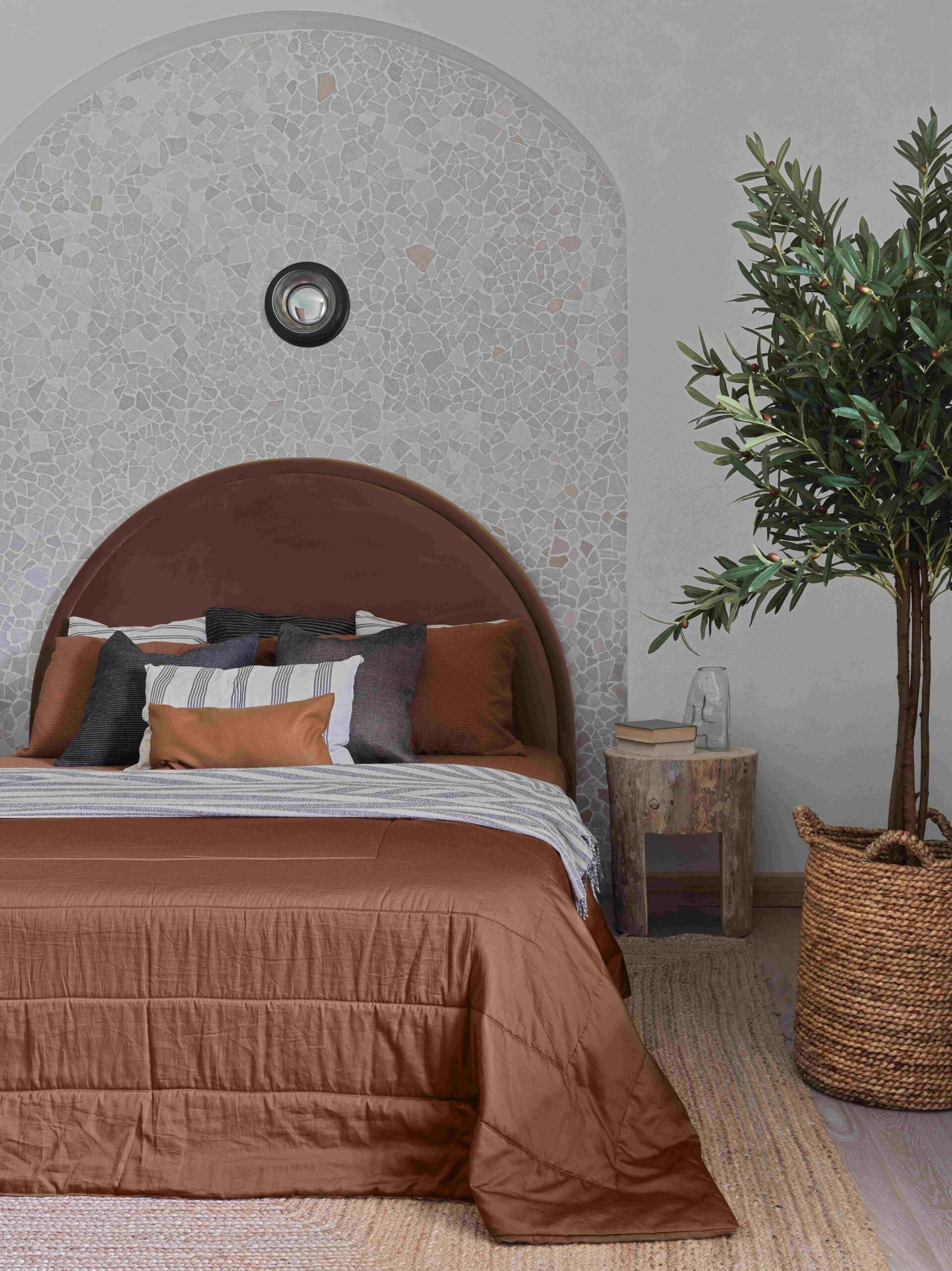 Pestovo House's bedroom with arched headboard and tree stump night stand.