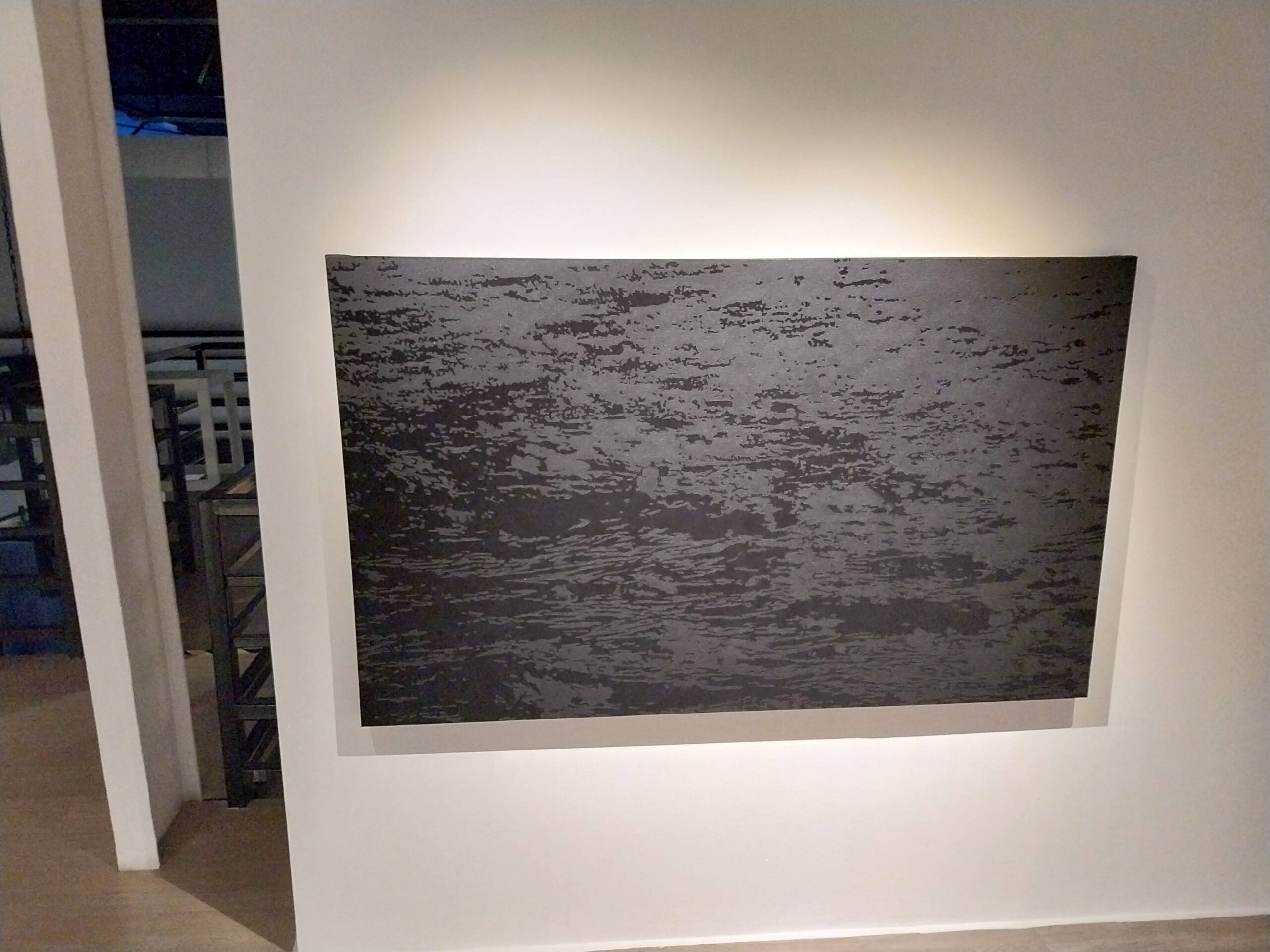 A painting of ocean waves. Photo by Elle Yap.