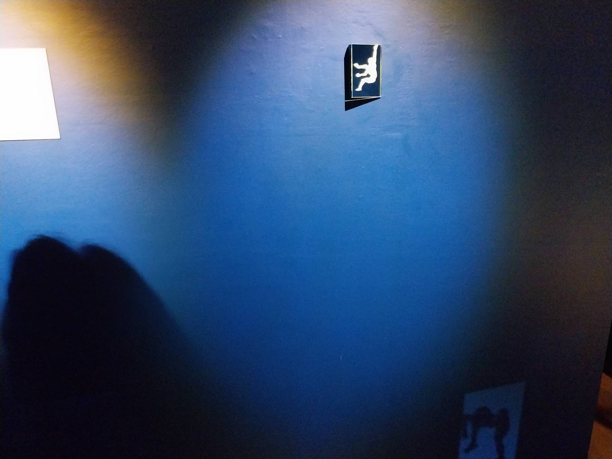 A mirror with a painting of someone mid-dance. Photo by Elle Yap.