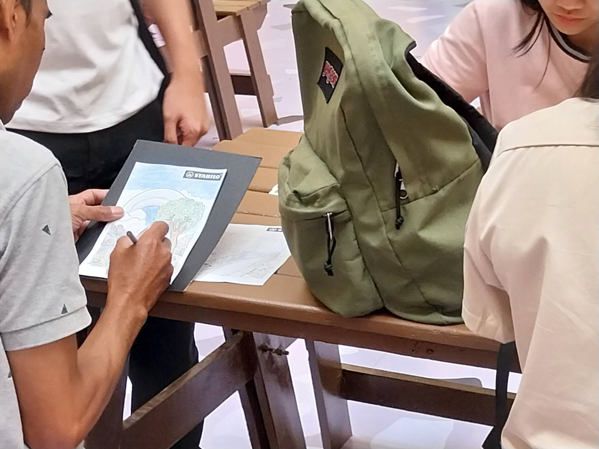 Someone focused on the artwork they are creating. Photo by Elle Yap.