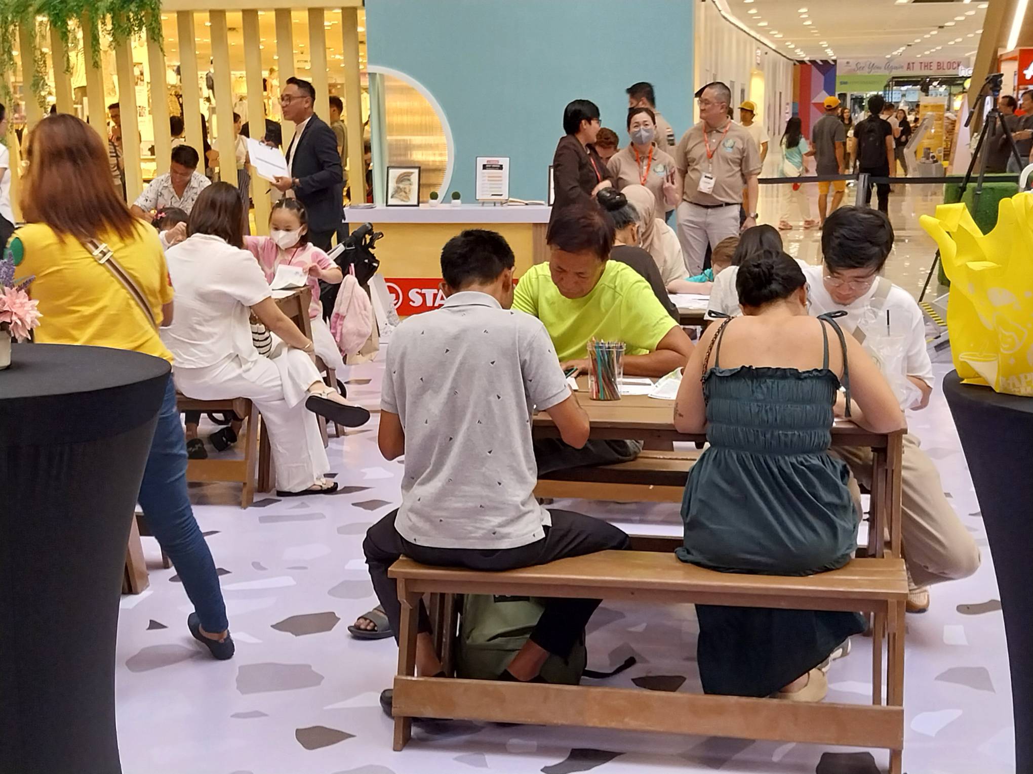 Adults in the task of making art. Photo by Elle Yap.