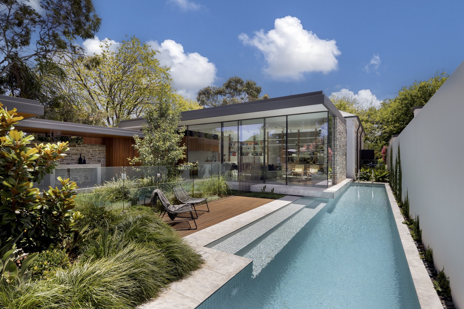 Side view of the swimming pool and living room. Photo by Art Department Creative.