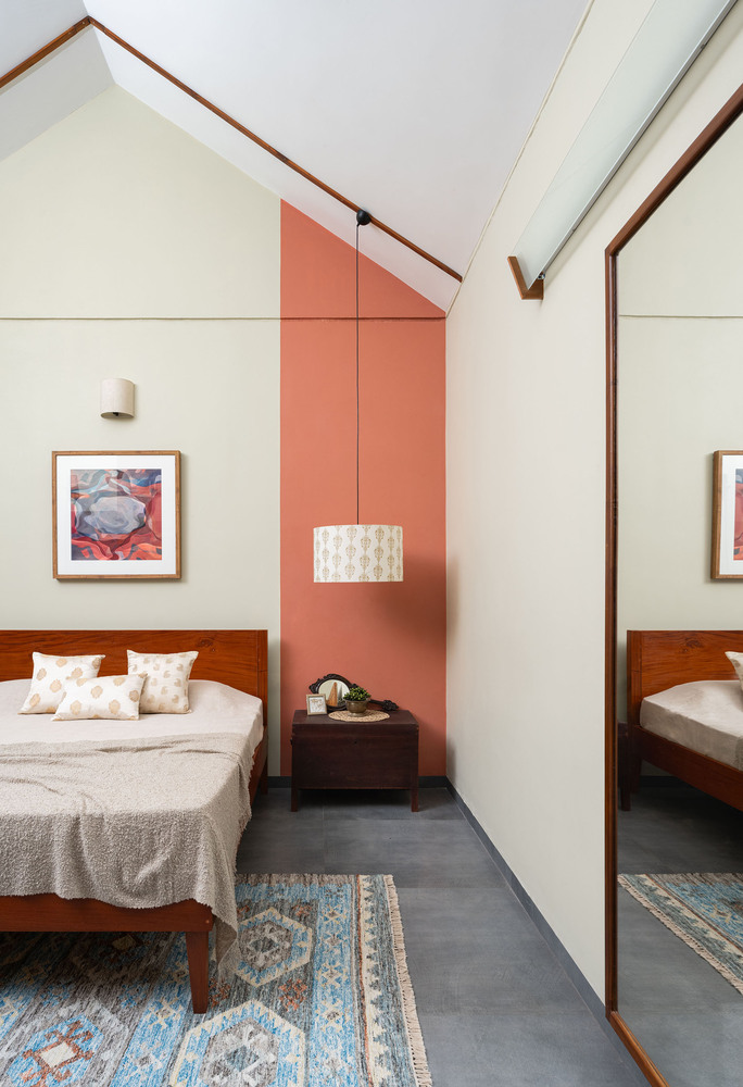 Vibrant Orange Accent Wall Surrounded by Warm Wood Tones.