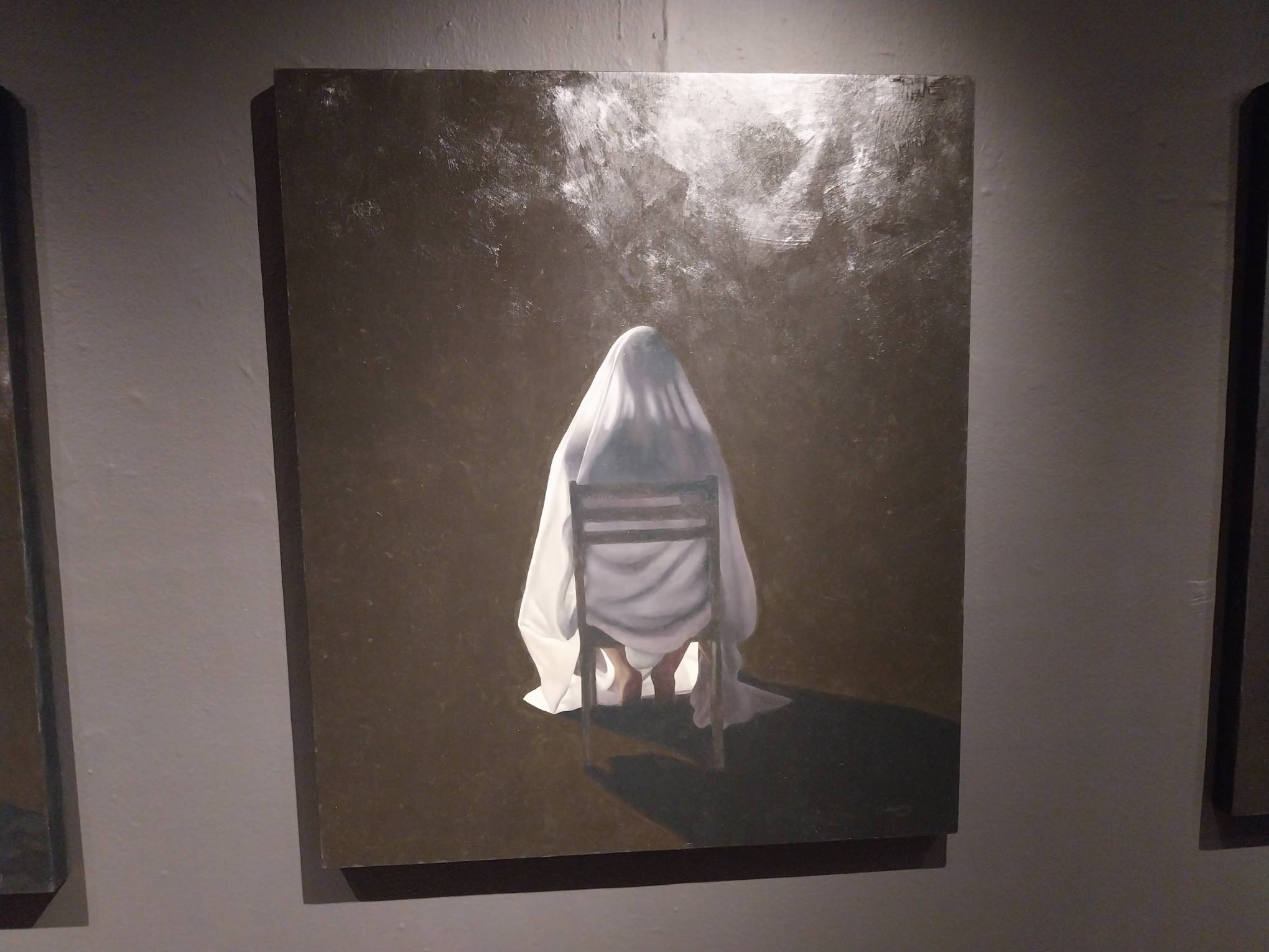 Boney figure painting covered by a sheet. Photo by Elle Yap.
