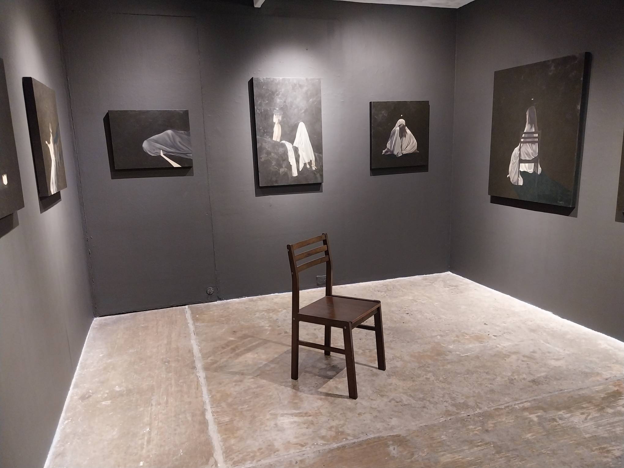 The wooden chair in the center of the exhibit. Photo by Elle Yap.
