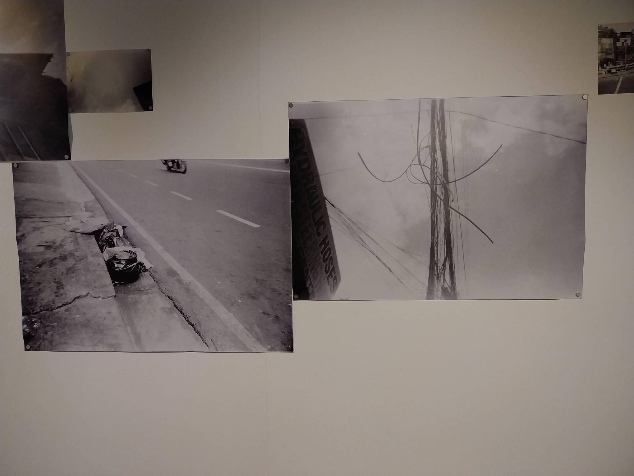 Photographs of frayed electrical wires and garbage on the street. Photo by Elle Yap.