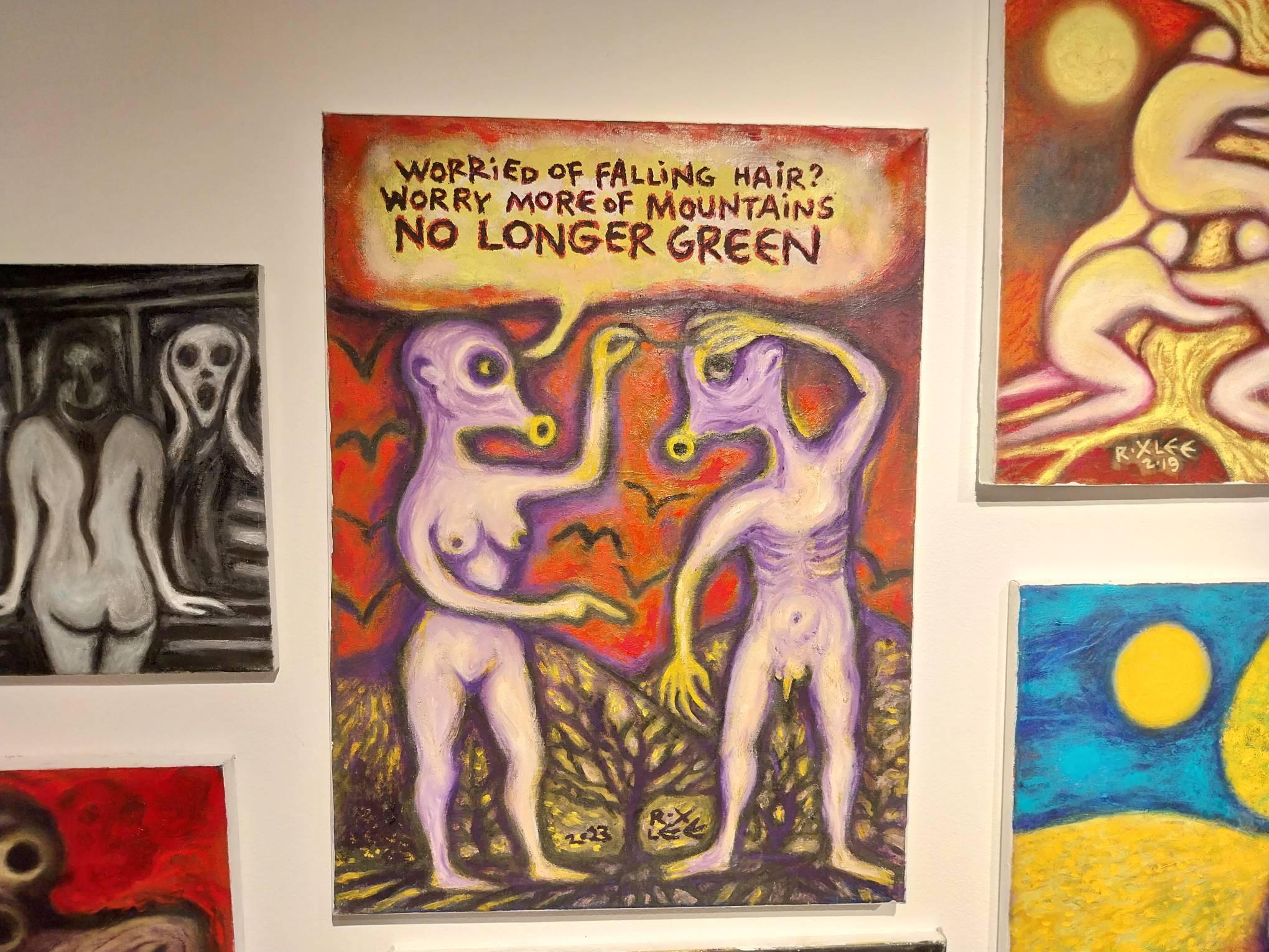 A painting by Roxlee of two figures in a forested red backdrop. Photo by Elle Yap.