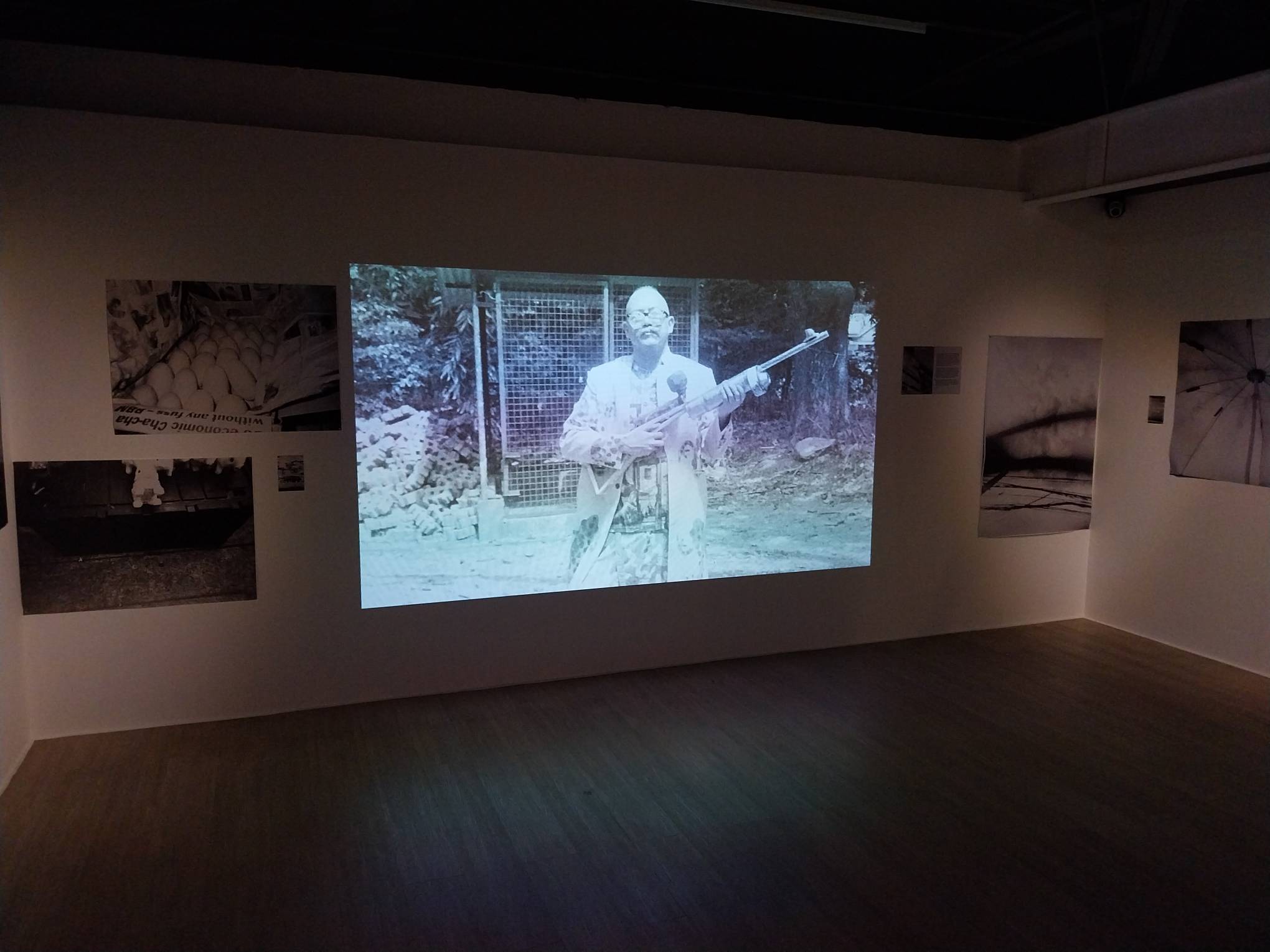Projected image of a man with a gun. Photo by Elle Yap.