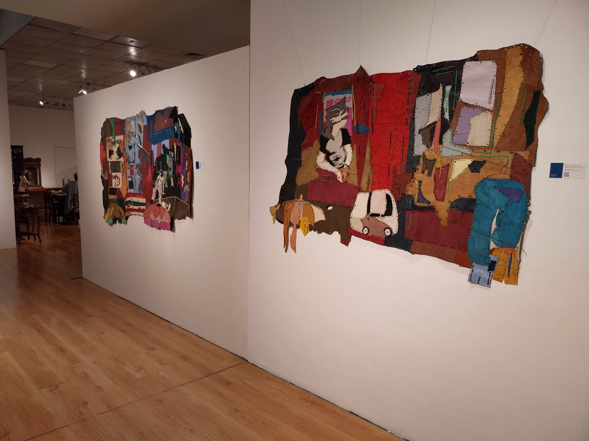 Two of the leather tapestry parts on the wall. Photo by Elle Yap.