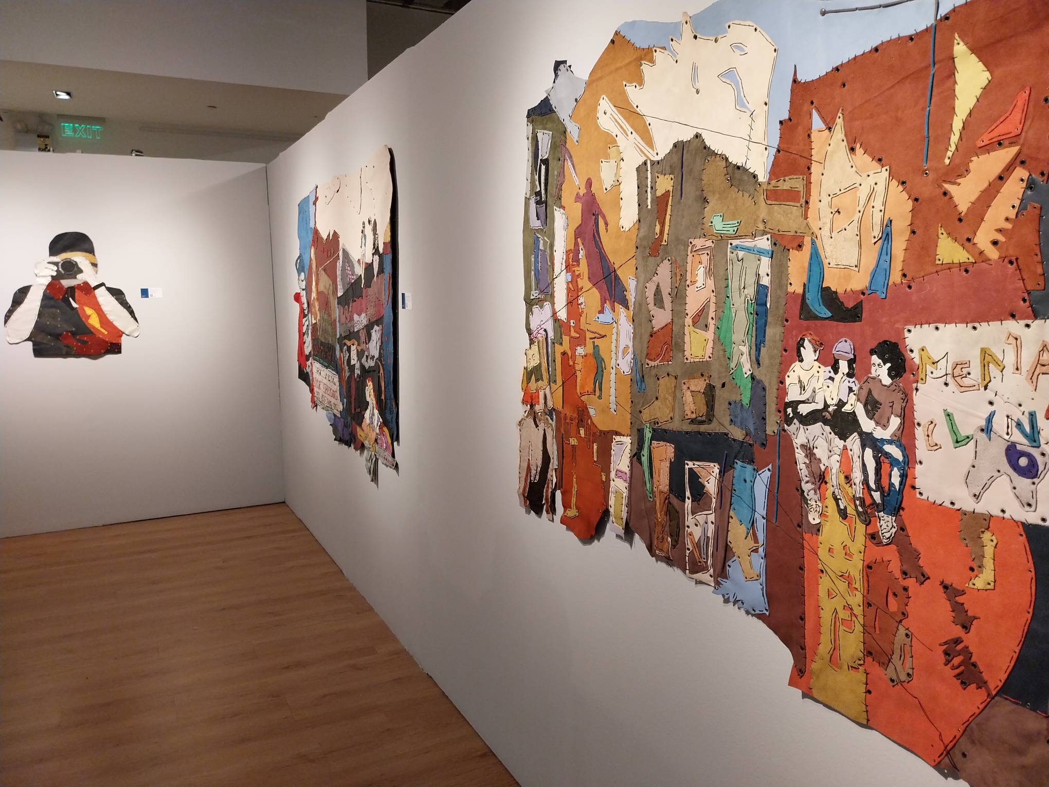 Three leather tapestry parts on the wall. Photo by Elle Yap.