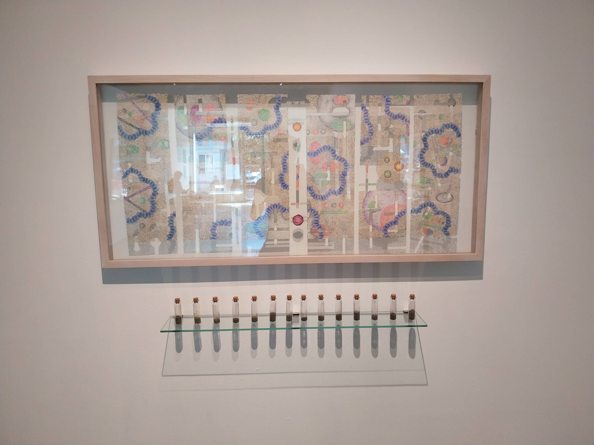 One of Julieanne Ng's works, with tiny jars of ashes littering the bottom. Photo by Elle Yap.