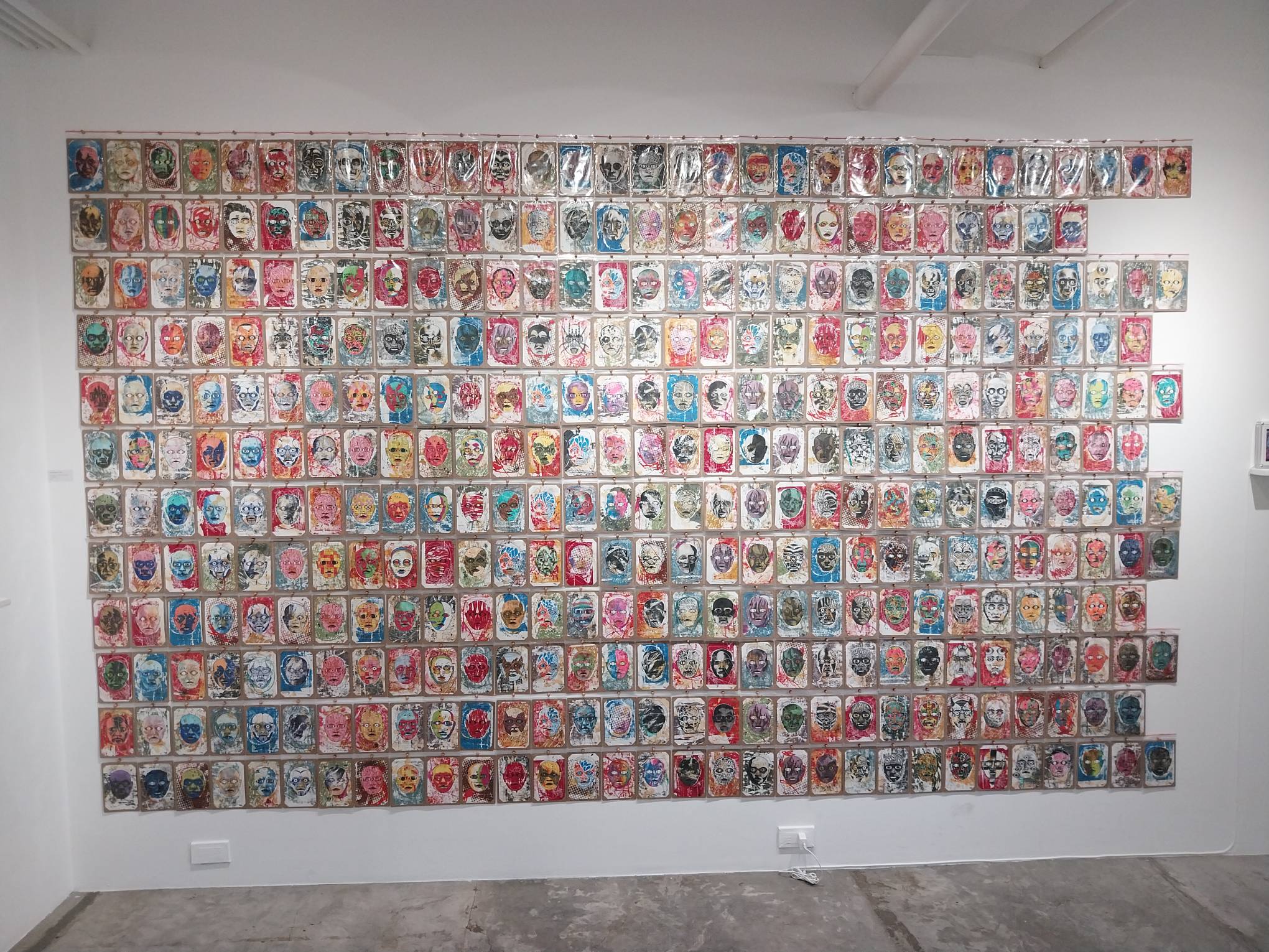 Wall of faces made by Epjey Pacheco. Photo by Elle Yap.