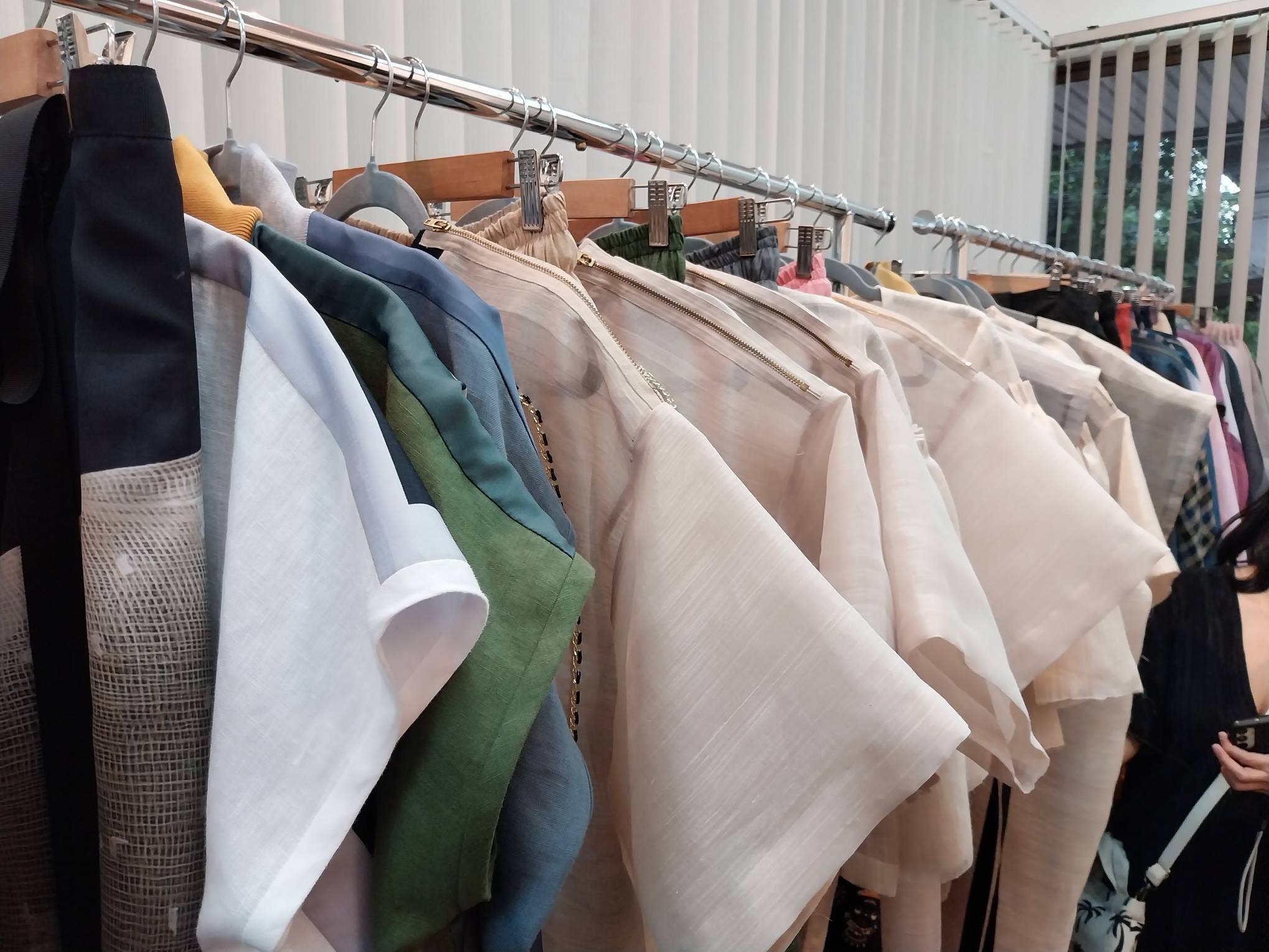 One of the racks filled with some of her designs. Photo by Elle Yap.