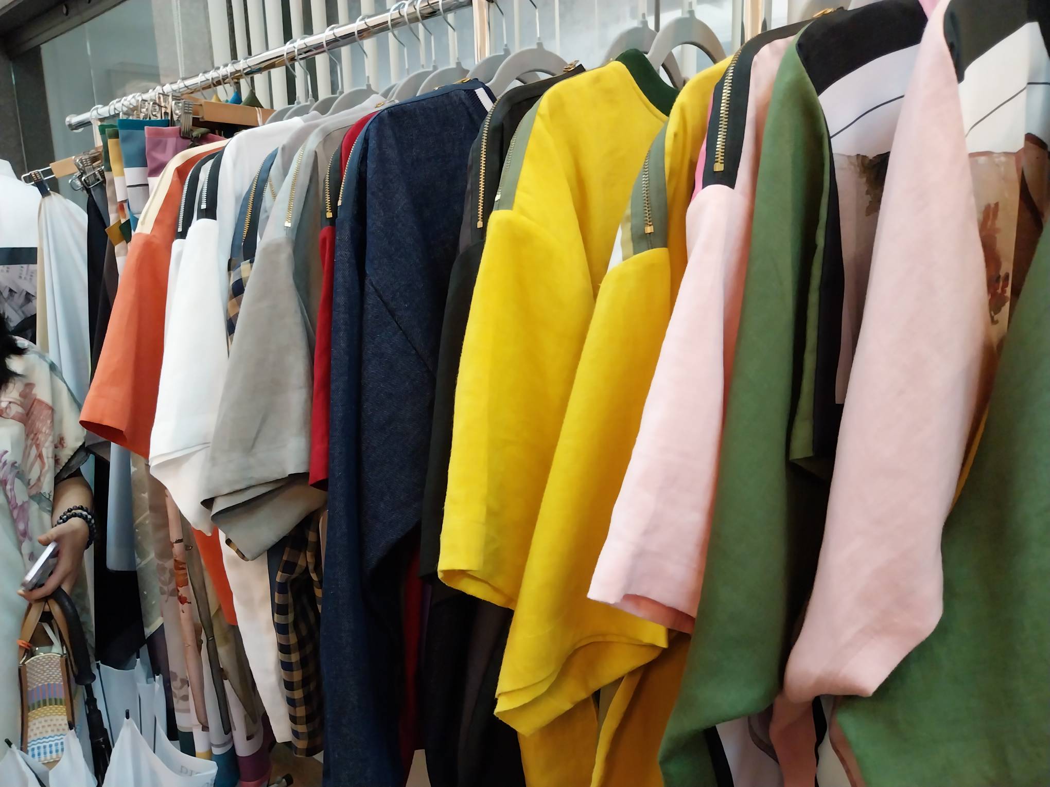 One of the racks filled with some of her designs. Photo by Elle Yap.
