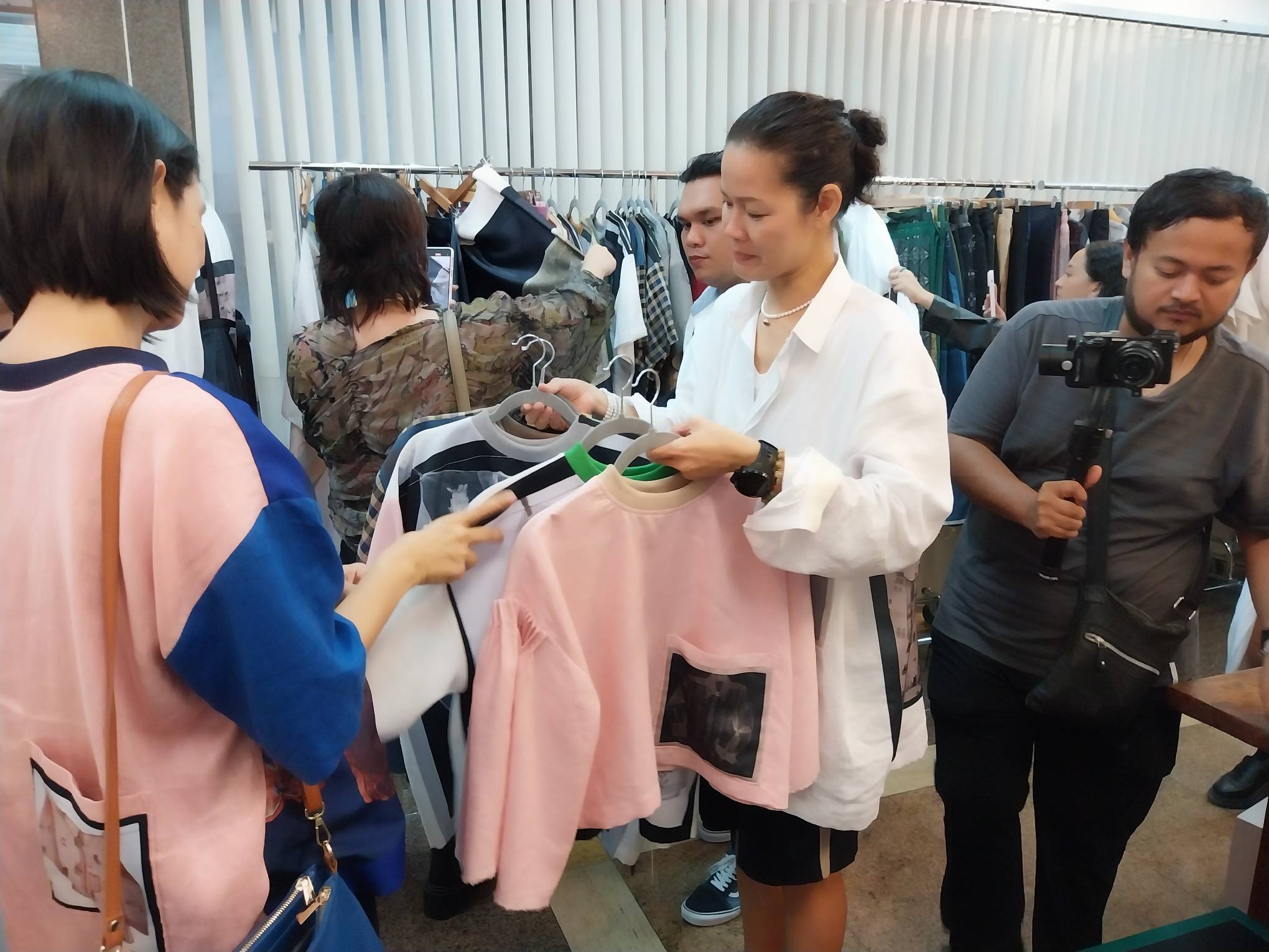 Bitagcol showing off her selection to an interested customer. Photo by Elle Yap.