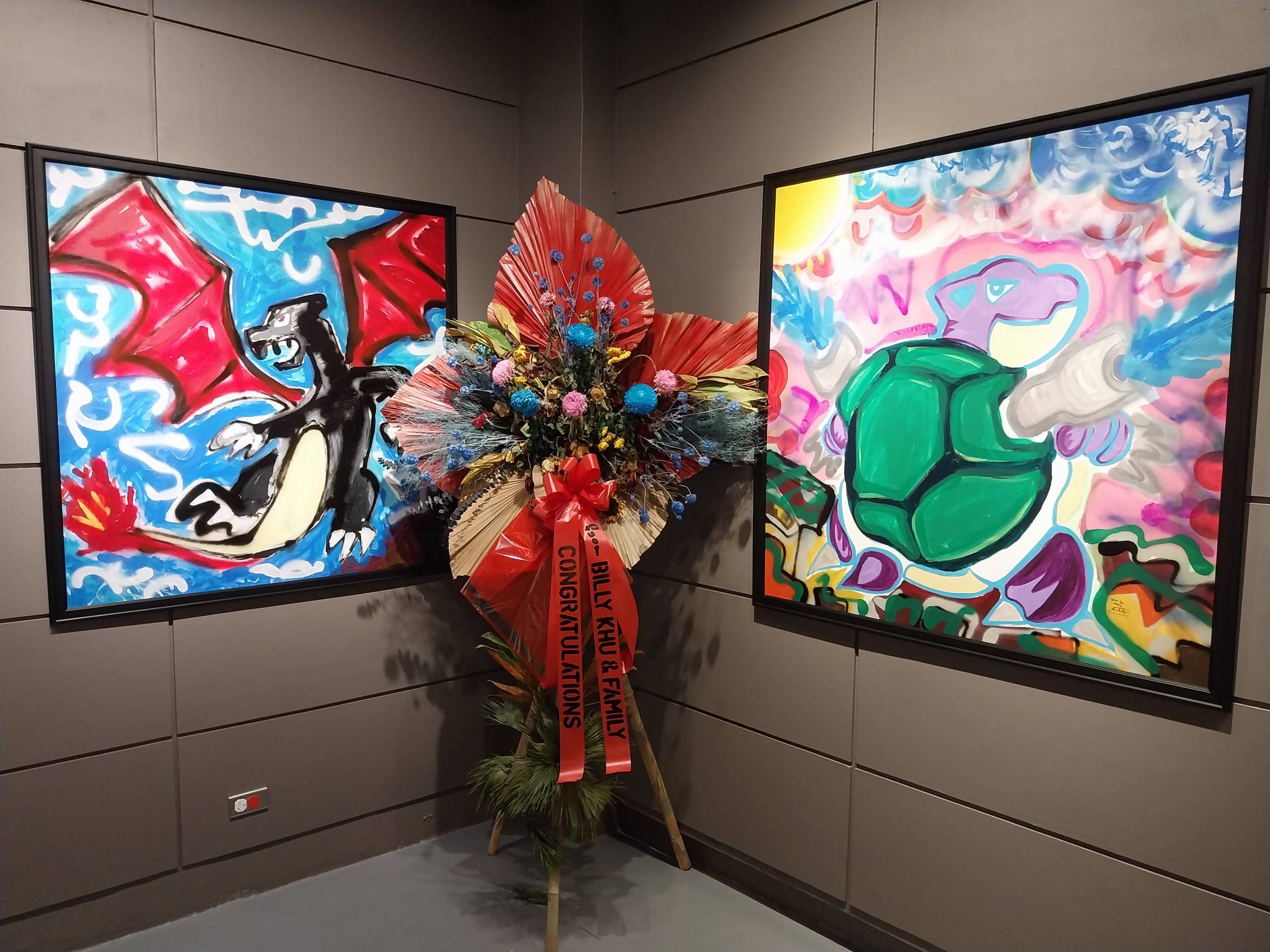 Two paintings of different Pokemon creatures. Photo by Elle Yap.