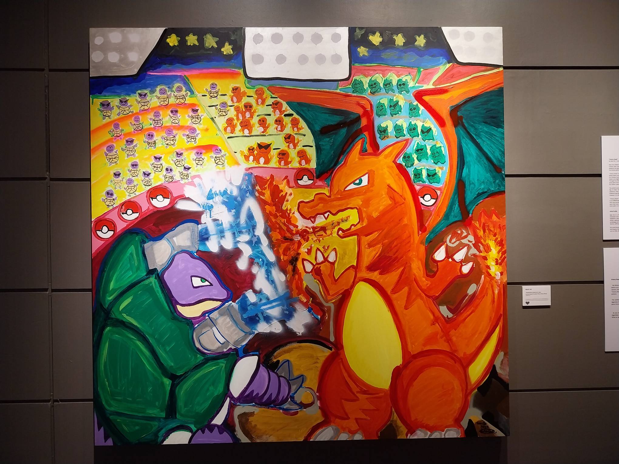 A painting of Pokemons in a stadium showcased in the exhibit. Photo by Elle Yap.