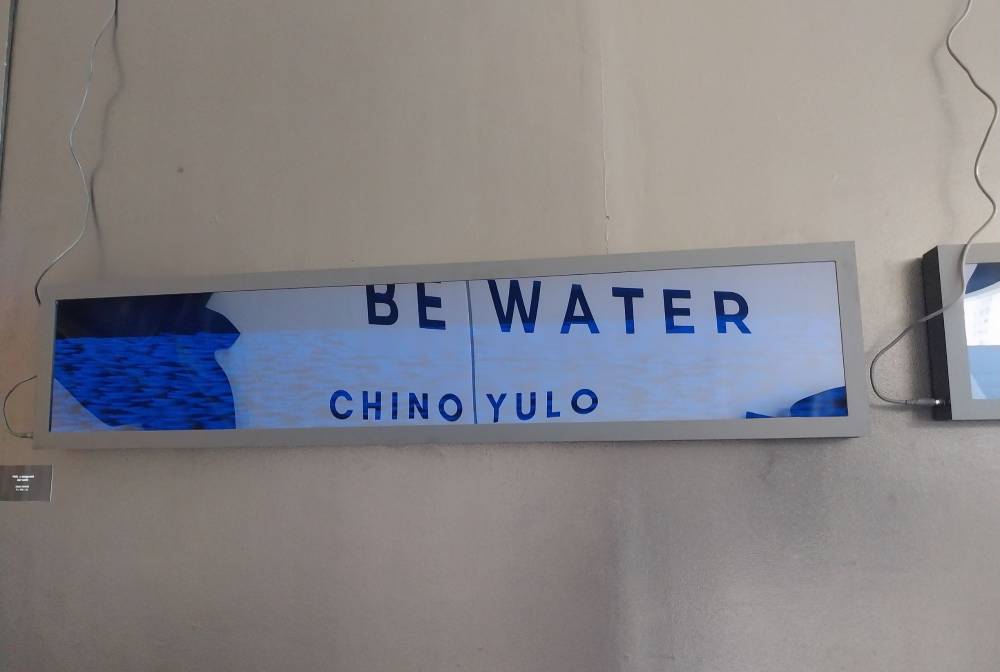 "Moonglade" by Chino Yulo with title reflecting on the surface. Photo by Elle Yap.