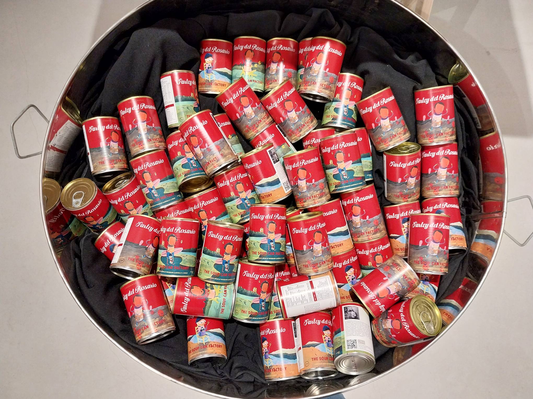 Cans of soup cans with Farley del Rosario's name and art in them. Photo by Elle Yap.