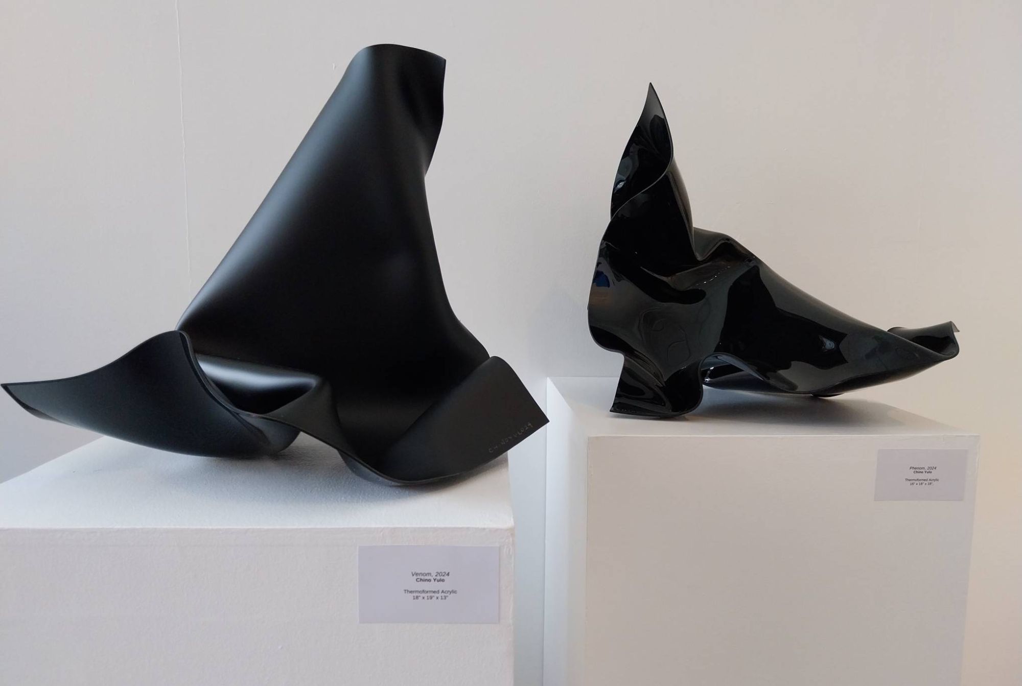 Two black sculptures by Chino Yulo in 