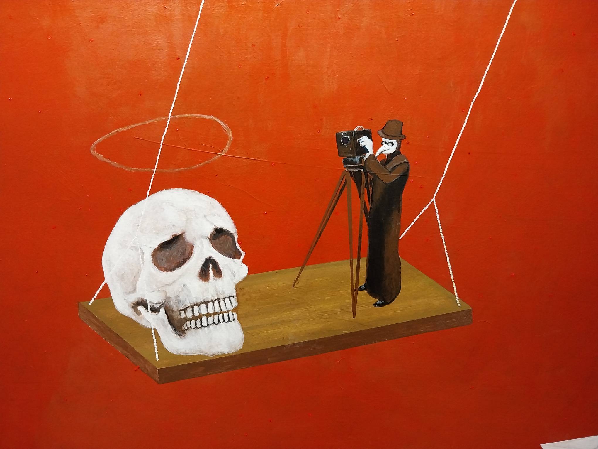 A skull and a plague doctor with a camera. Photo by Elle Yap.