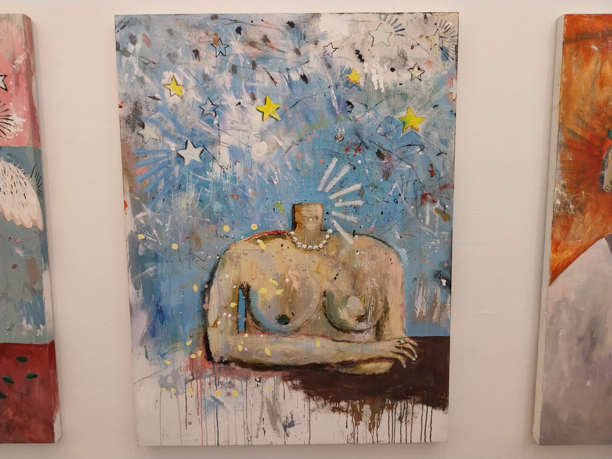 Painting of a headless torso with crossed arms. Photo by Elle Yap.